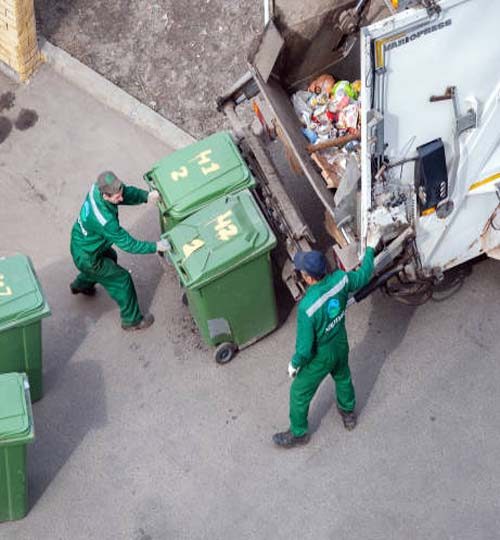 Workers pick residential solid waste loading garbage truck, Moscow,15.04.2021