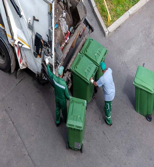 garbage men loading household rubbish in garbage truck, view from above - Moscow, 03/07/2020