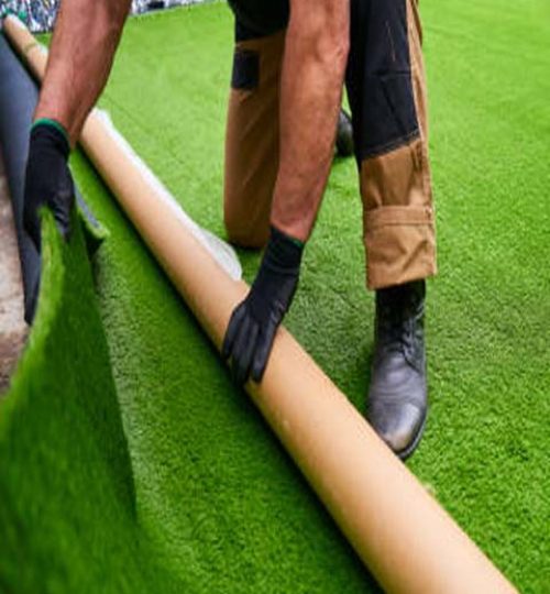 Installing artificial grass in modern garden of home